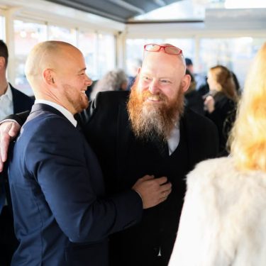 Candid scene of business professionals enjoying a jovial moment together indoors.